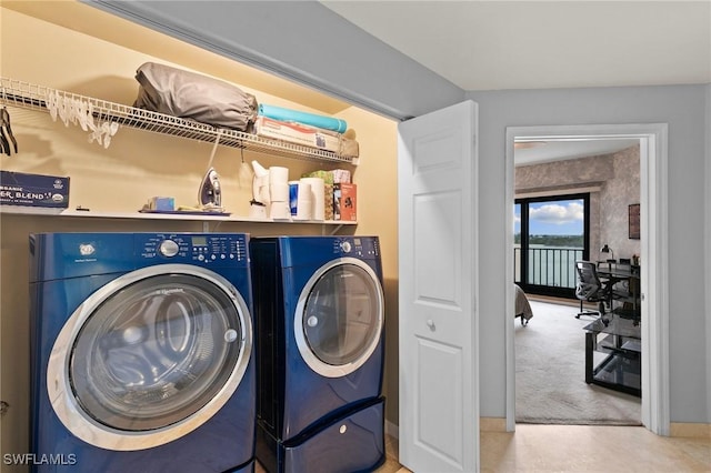 washroom with washing machine and dryer and carpet