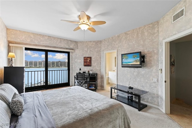 carpeted bedroom featuring connected bathroom, access to exterior, and ceiling fan