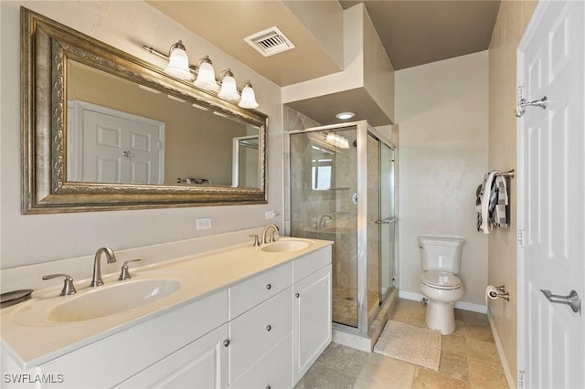 bathroom featuring a shower with door, vanity, and toilet