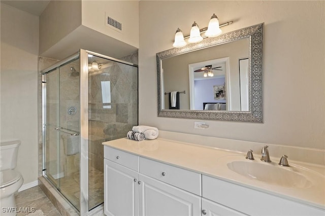 bathroom with tile patterned flooring, toilet, vanity, and walk in shower