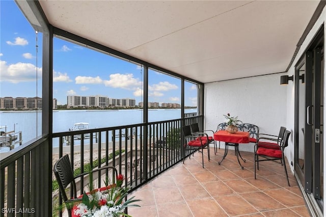 sunroom / solarium featuring a water view