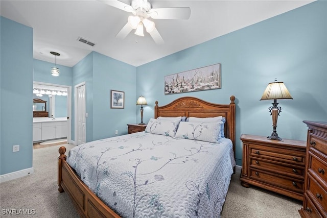 bedroom with light carpet, connected bathroom, and ceiling fan