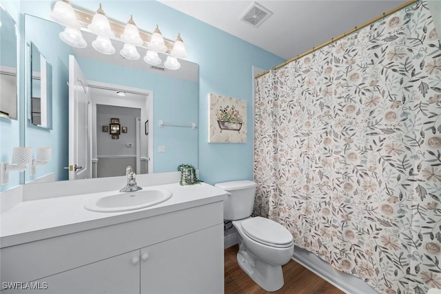 bathroom with hardwood / wood-style flooring, vanity, and toilet