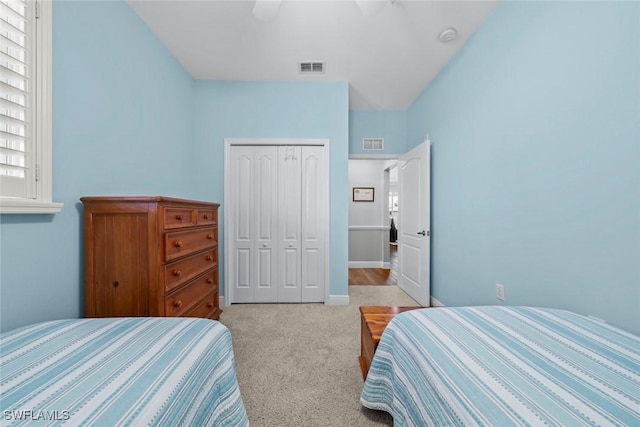 bedroom featuring ceiling fan, light colored carpet, and a closet