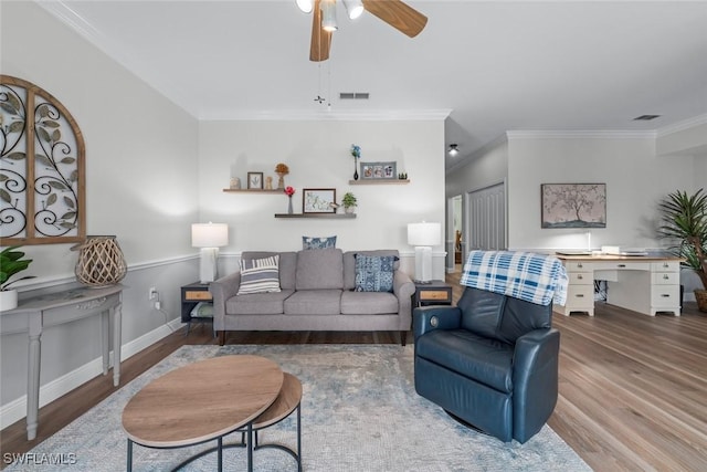 living room with hardwood / wood-style floors, crown molding, and ceiling fan