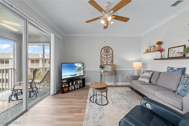 living room featuring crown molding, light hardwood / wood-style flooring, and ceiling fan