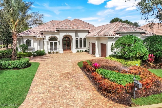 mediterranean / spanish-style house with french doors and a garage