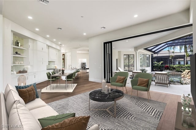 living room featuring sink and light hardwood / wood-style floors