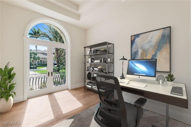 office with french doors and light wood-type flooring