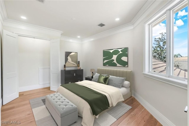 bedroom featuring crown molding and light wood-type flooring