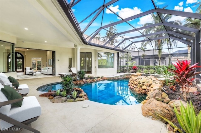 view of swimming pool featuring an outdoor hangout area, a patio area, and glass enclosure