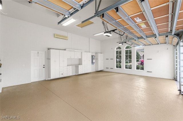 garage featuring a garage door opener and a wall mounted air conditioner