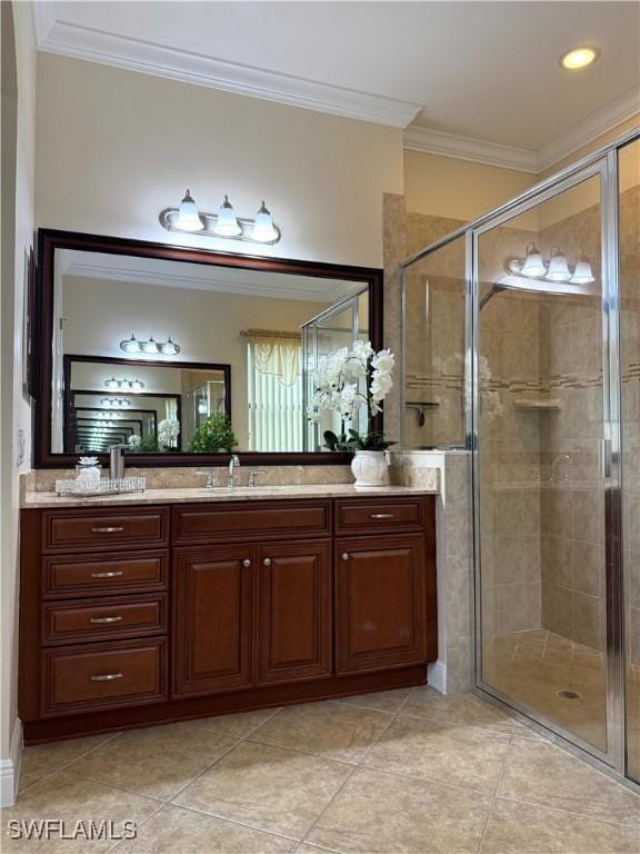 bathroom featuring an enclosed shower, vanity, crown molding, and tile patterned flooring