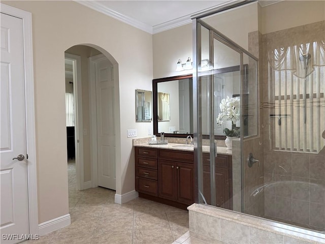 bathroom with tile patterned floors, ornamental molding, a shower with door, and vanity