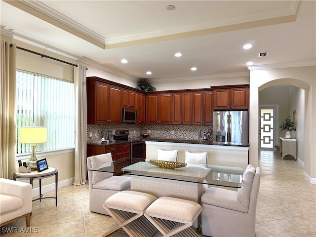 kitchen with crown molding, appliances with stainless steel finishes, light tile patterned floors, and plenty of natural light