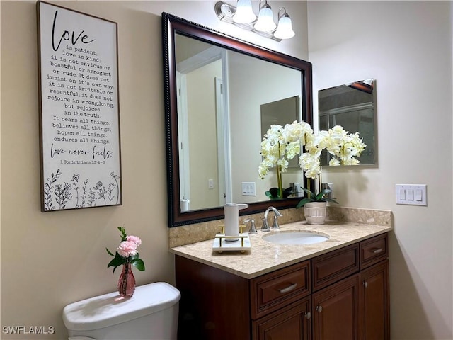 bathroom with vanity and toilet