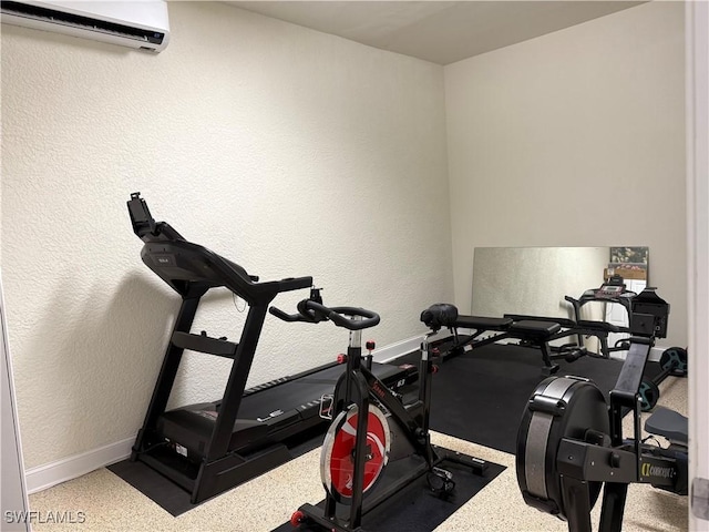 exercise room with a wall mounted air conditioner