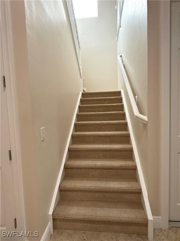 staircase with tile patterned flooring