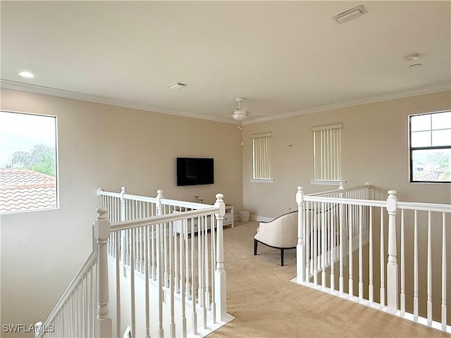 hallway featuring crown molding and light colored carpet