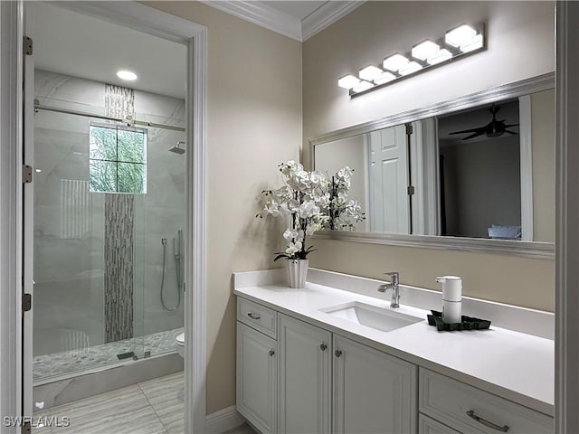 bathroom with vanity, crown molding, a shower with door, and toilet