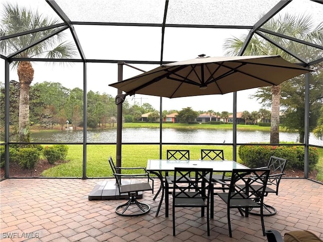 sunroom featuring a water view