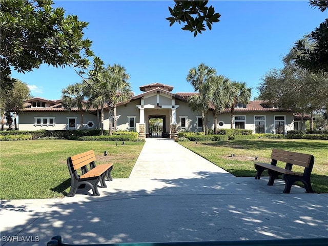 mediterranean / spanish house featuring a front yard