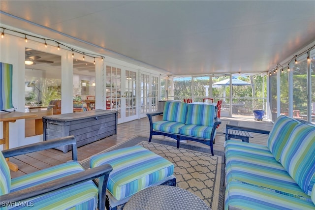 sunroom / solarium featuring rail lighting