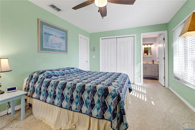 carpeted bedroom featuring ceiling fan, connected bathroom, and a closet