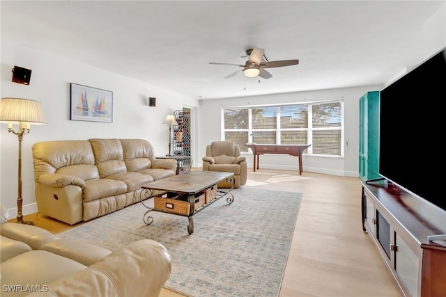 living room featuring ceiling fan and light hardwood / wood-style floors