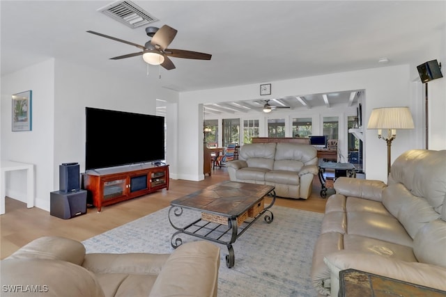 living room featuring light hardwood / wood-style flooring and ceiling fan