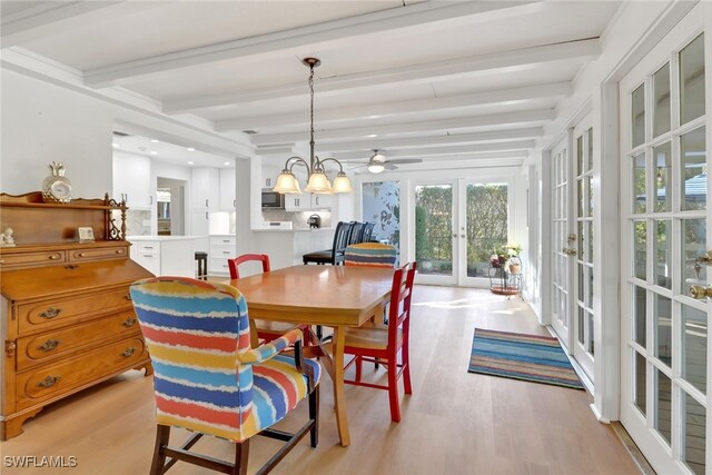 dining room featuring beamed ceiling, light hardwood / wood-style flooring, an inviting chandelier, and french doors