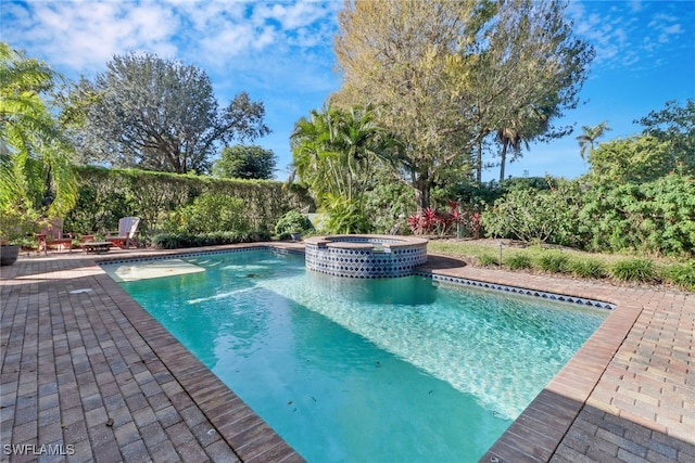 view of pool featuring an in ground hot tub and a patio area