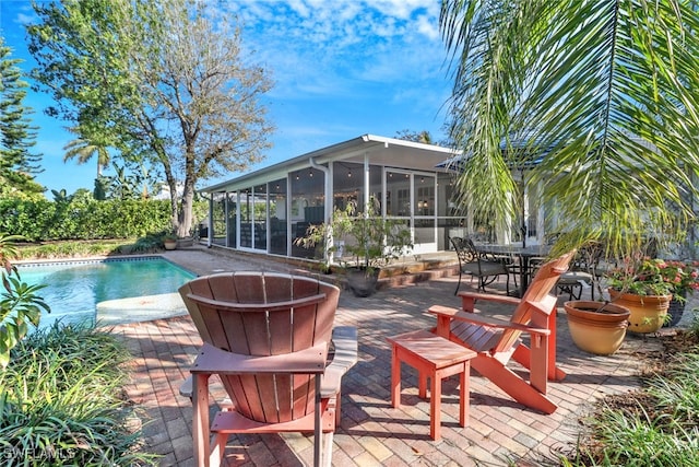 view of swimming pool featuring a patio and a sunroom