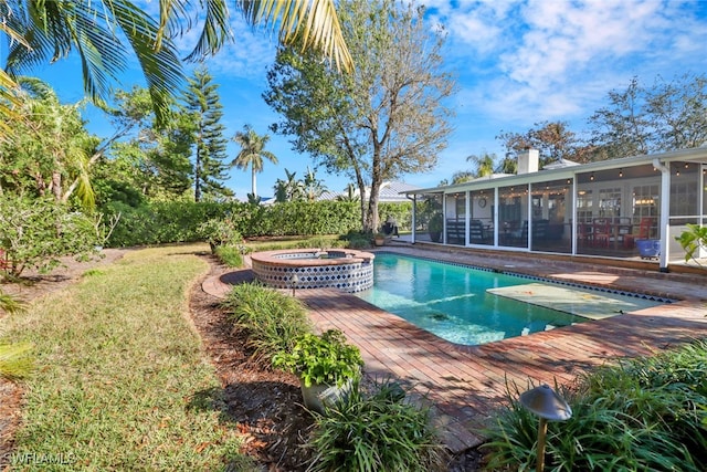 view of swimming pool with an in ground hot tub and a sunroom