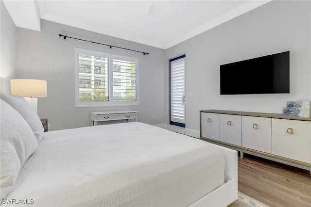 bedroom with ceiling fan, crown molding, access to exterior, and light wood-type flooring