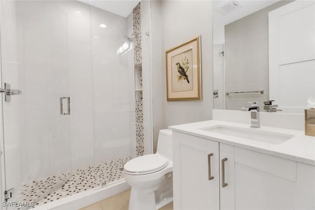 bathroom with a shower with door, vanity, and toilet