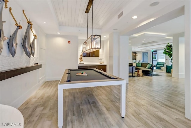 game room featuring billiards, a tray ceiling, light wood-type flooring, wooden ceiling, and indoor bar