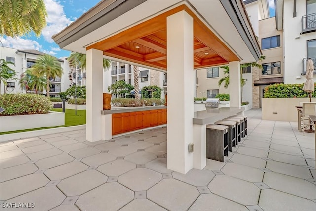 view of patio featuring area for grilling, a grill, a gazebo, and sink