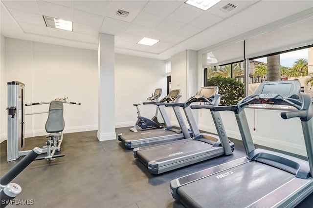 gym with a paneled ceiling