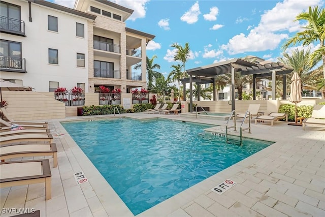 view of swimming pool with a patio area and a pergola