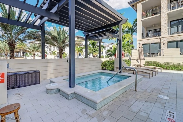 view of swimming pool featuring a hot tub, a patio, and a pergola