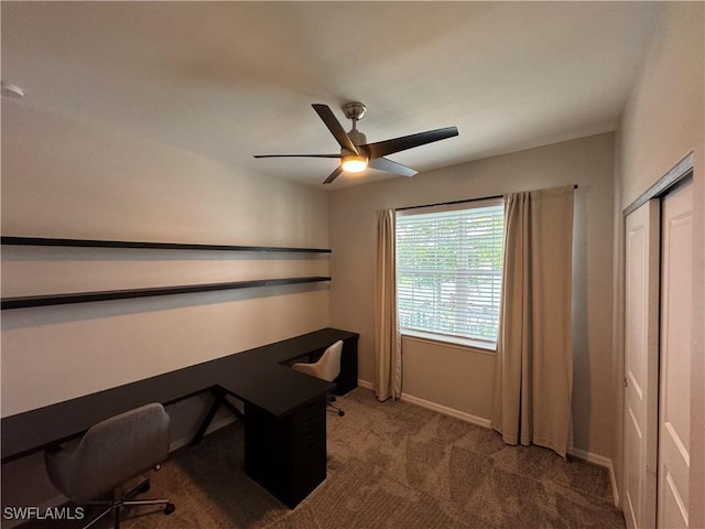 carpeted home office featuring ceiling fan