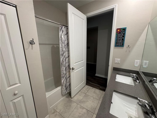 bathroom with shower / tub combo with curtain, vanity, and tile patterned floors