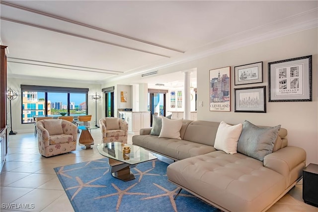 living room with ornamental molding, plenty of natural light, and decorative columns