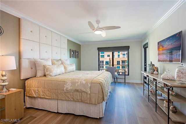 bedroom with a ceiling fan, baseboards, ornamental molding, and wood finished floors