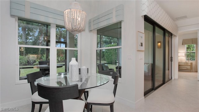 tiled dining space featuring a chandelier