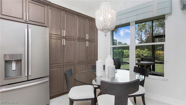 dining area with an inviting chandelier and plenty of natural light