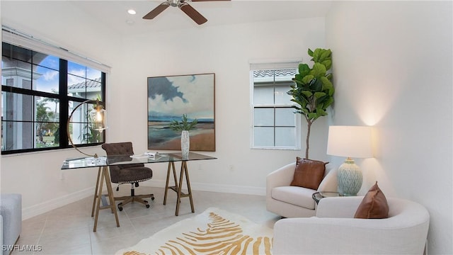 office area with light tile patterned floors and ceiling fan