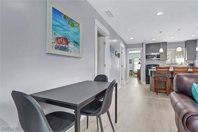 dining space with light wood-type flooring