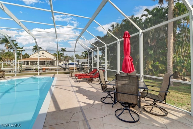 view of swimming pool featuring a lanai and a patio area